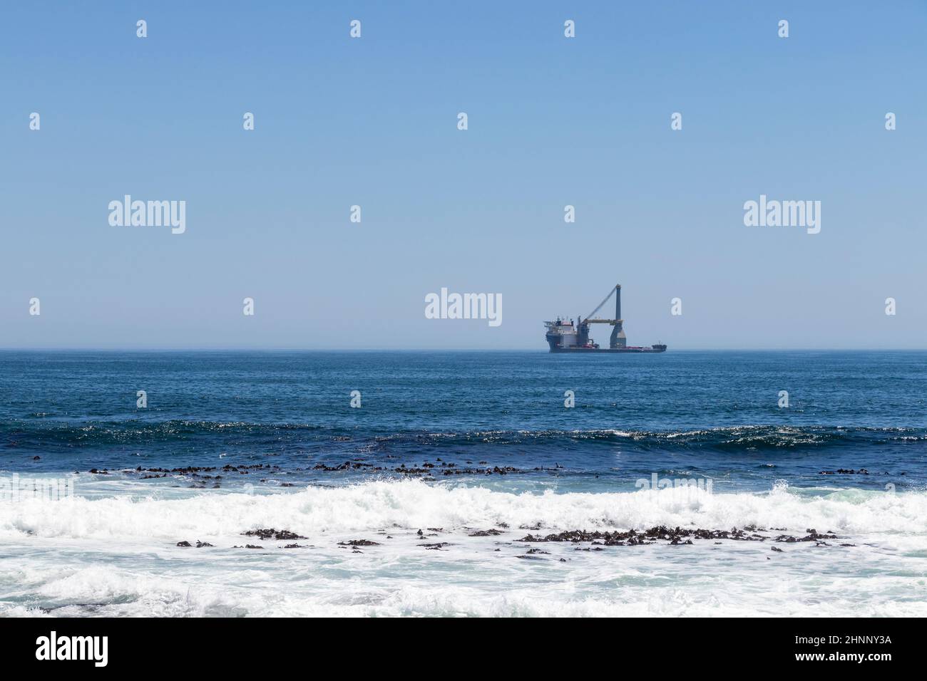 Ship very far away in the ocean, Sea Point. Stock Photo