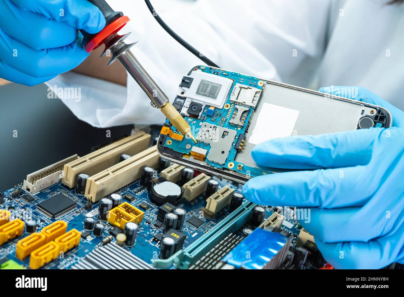 technician repairing inside of hard disk by soldering iron. Integrated