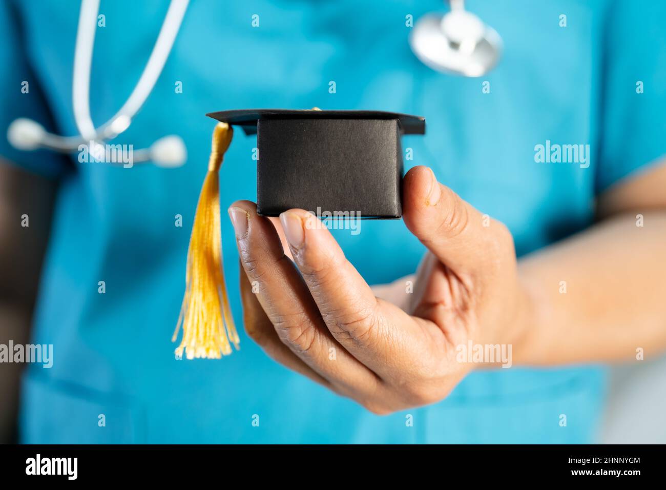 Doctoe Graduation Asian doctor study learn with graduation gap hat in hospital ward ...