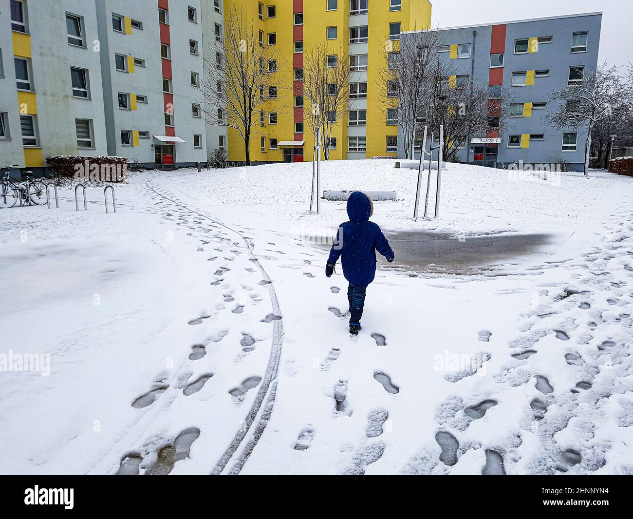 Child runs through the snow in Leherheide, Bremerhaven. Stock Photo