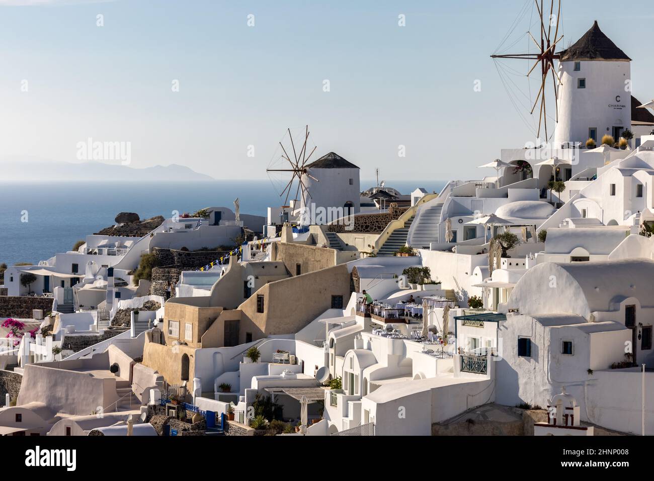 Whitewashed houses and windmills in Oia on Santorini island, Cyclades, Greece Stock Photo