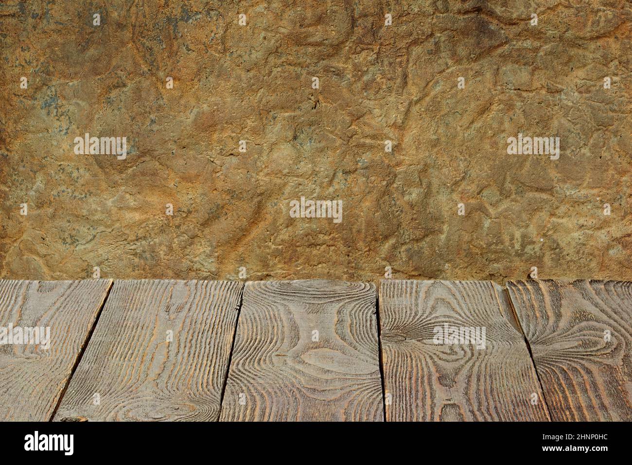 The background is blank wooden boards and a textured plastered wall