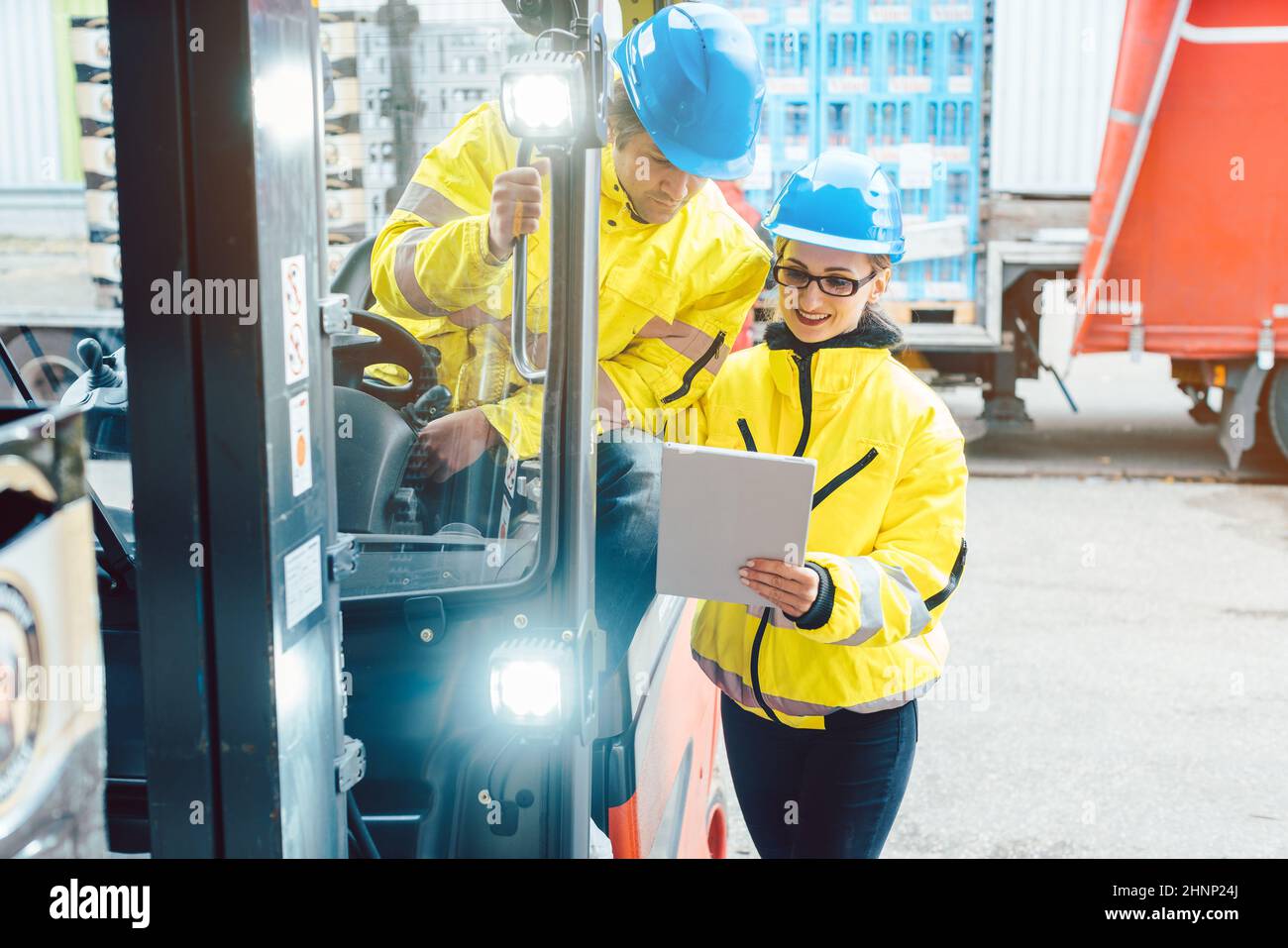 Forklift driver and forewoman discussing where to store delivery of goods Stock Photo