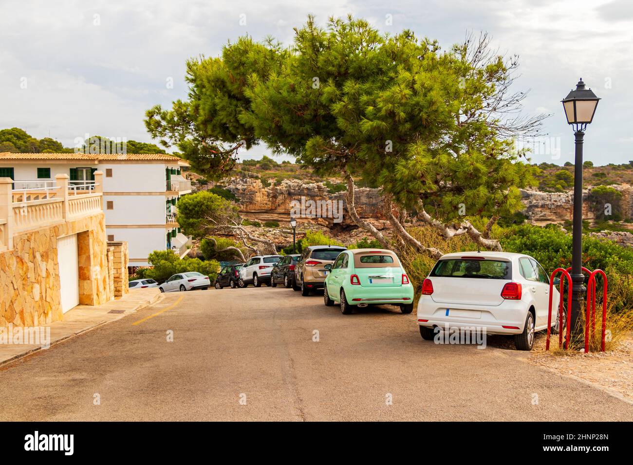 Typical street with parked cars in Cala Figuera Mallorca Spain. Stock Photo