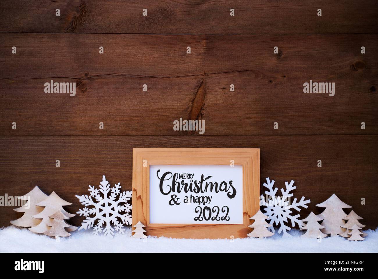 English Calligraphy Merry Christmas And Happy 22 White Christmas Ornament Like Snowflake And Tree Wooden Background With Snow Stock Photo Alamy