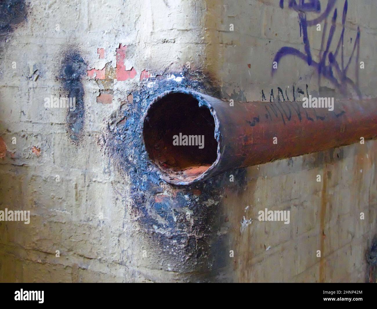 Rusty steel pipe in the empty industrial building Stock Photo