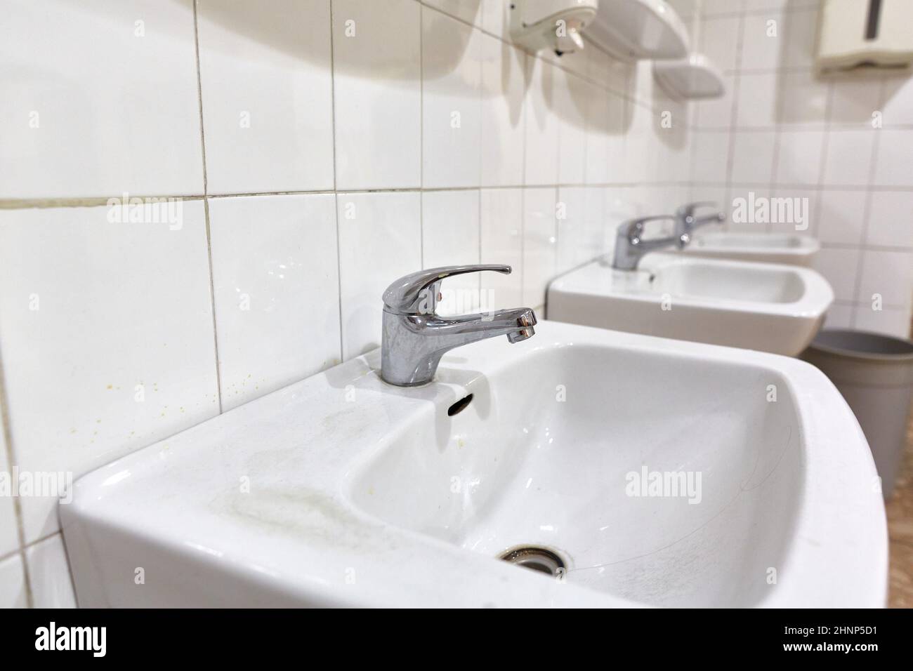 Taps in a public restroom Stock Photo Alamy
