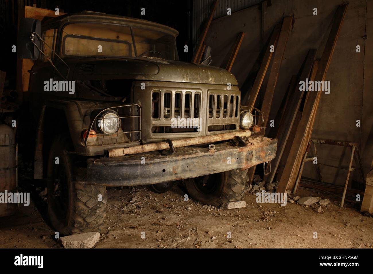 old army truck in a dark garage Stock Photo