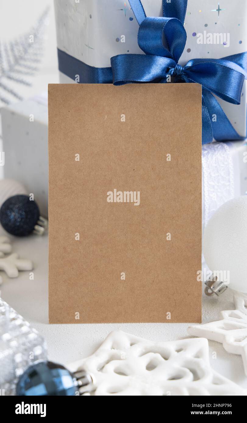 Kraft Paper card and envelope near Blue, white and silver Christmas