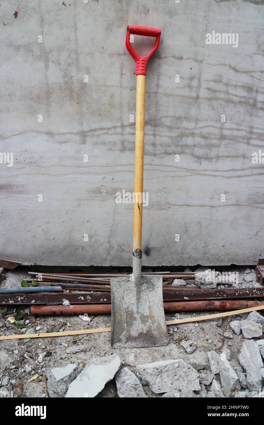 shovel leaned against the wall Stock Photo