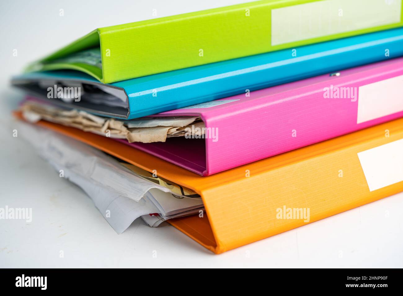 File Folder Binder stack of multi color on table in business office. Stock Photo