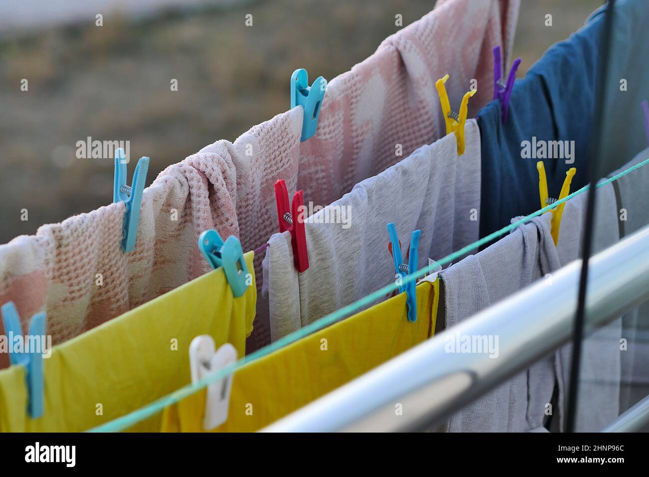 Washed laundry hanging with clothespins on the balcony, laundry drying