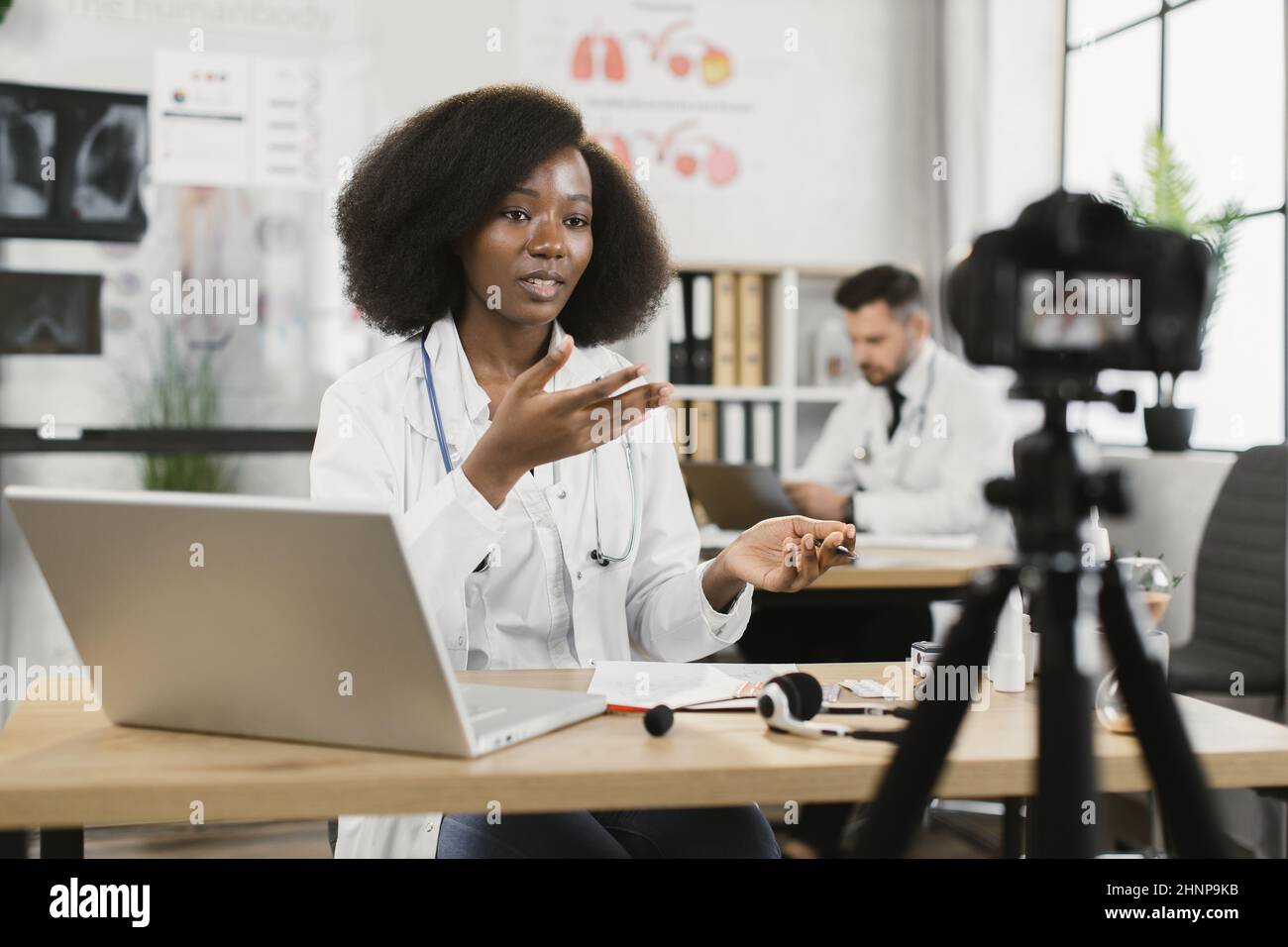 Male doctor talking camera explaining hi-res stock photography and ...
