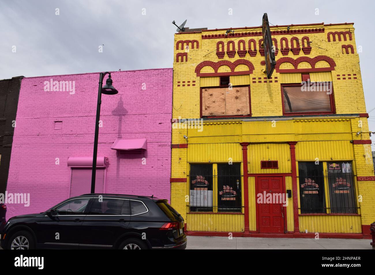 Colorful facades on Winder St and in yellow the now permanently closed Butcher's Inn pub in the Eastern Market area of Detroit, Michigan, USA. Stock Photo