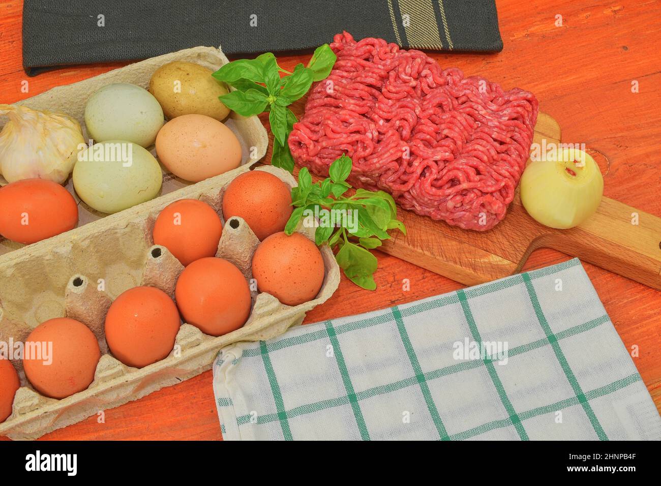 Mince. Ground meat with ingredients for cooking. Mixed minced meat ready to making burgers, fatty's, meaetballs. Food photography. Culinary concept. Minced meat recipe Stock Photo
