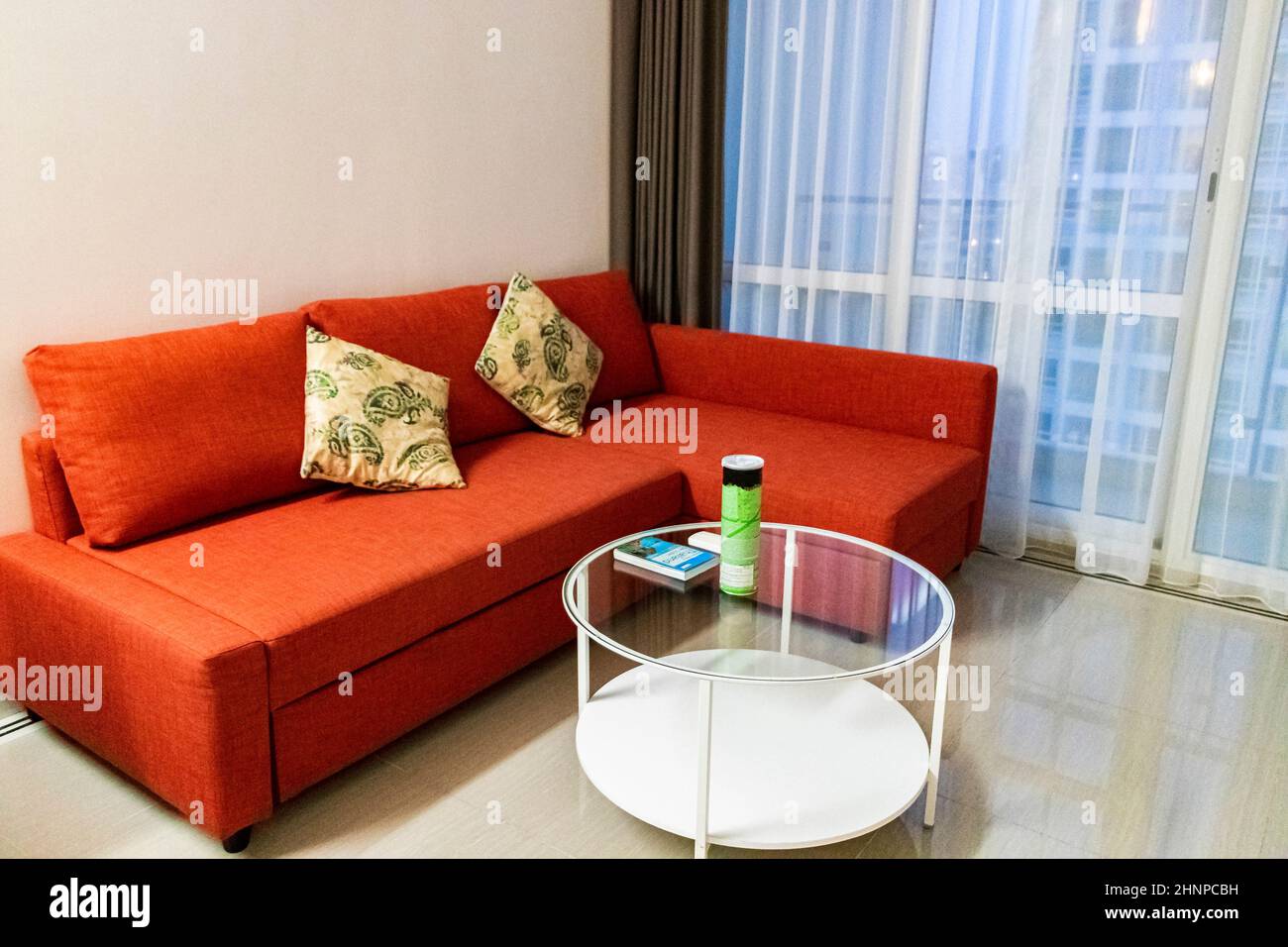 Super clean luxury apartment with red couch Bangkok Thailand. Stock Photo