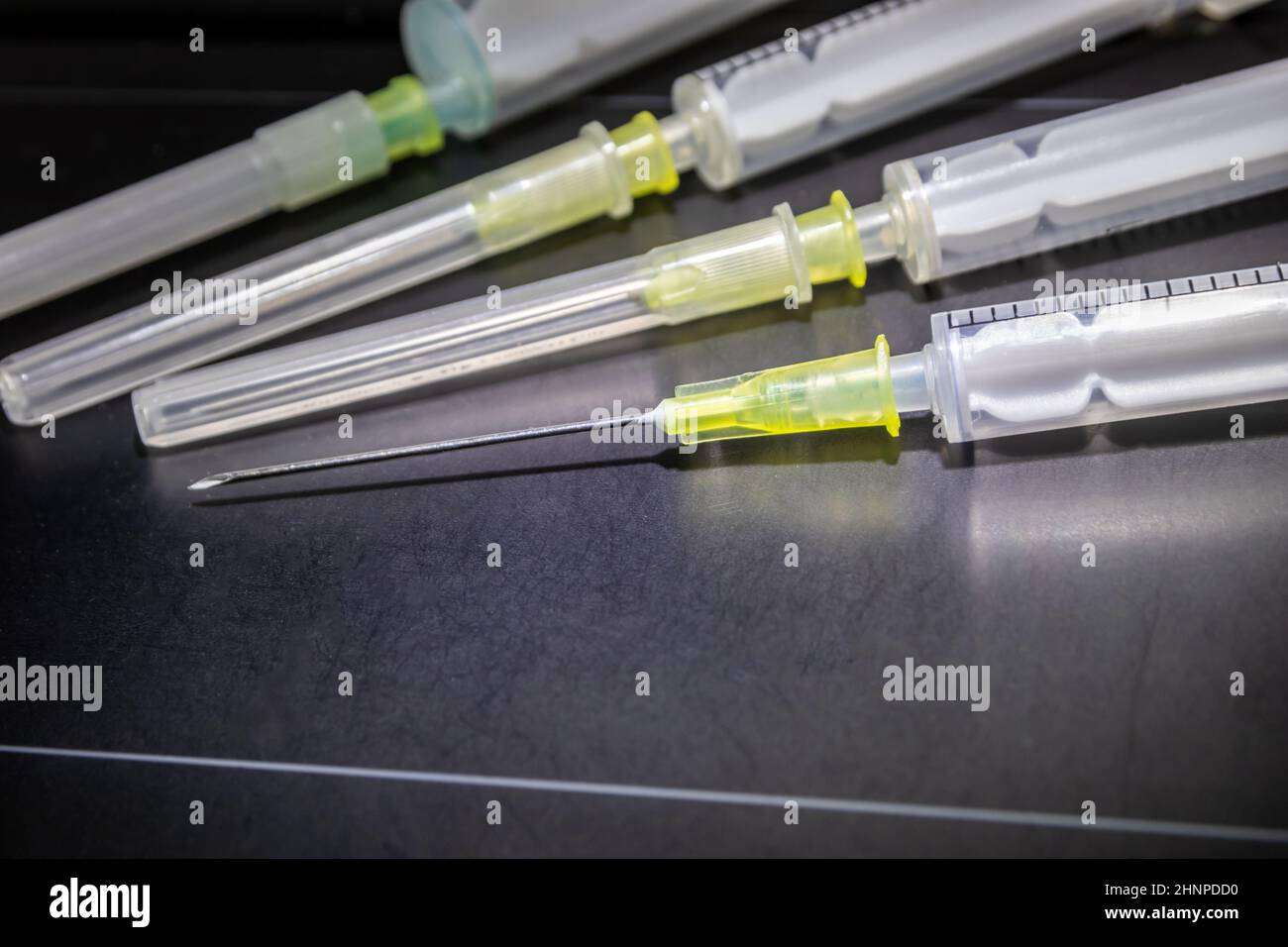 New medical vaccines ready for injection with syringe and vaccine to inject the cure for immunization into ill and weak patients to heal their suffers and illnesses supported corona health care system Stock Photo