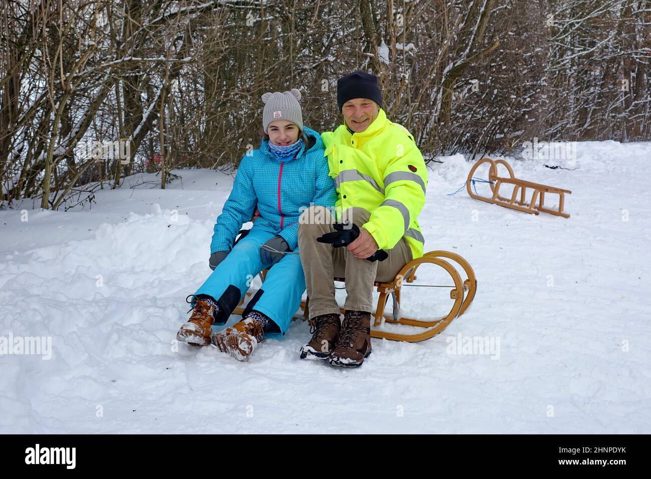 Bavaria, Upper Bavaria, 10 years old girl, smile, grandfather, happy,  sleds, Landkreis Munich Stock Photo