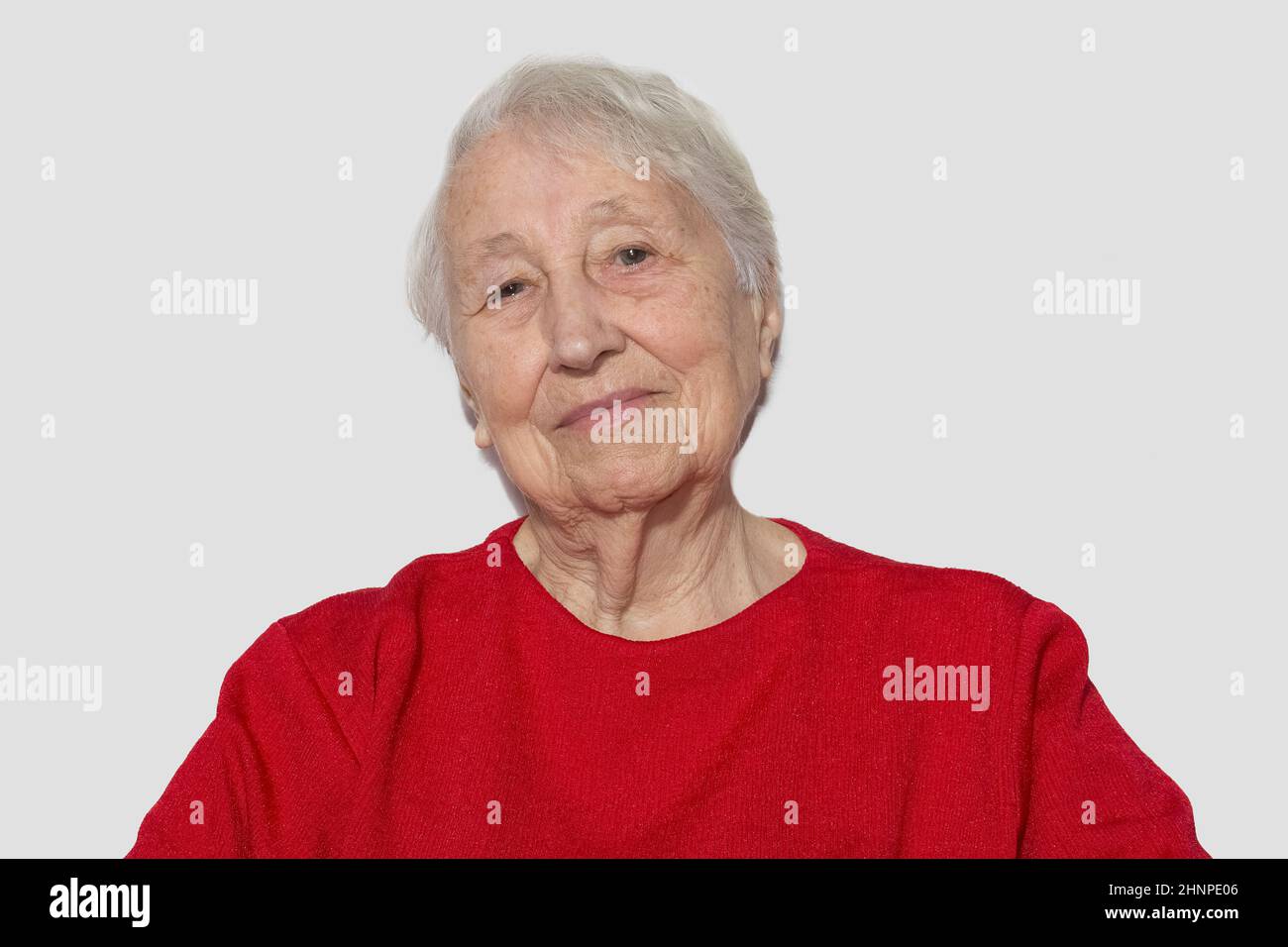 Portrait of a dreaming senior woman sitting with closed eyes. Stock Photo