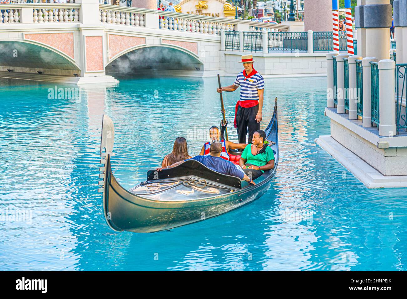 gondola with tourists at The Venetian Resort Hotel & Casino The resort opened  1999 with flutter of white doves, sounding trumpets, singing gondoliers and actress Sophia Loren. Stock Photo