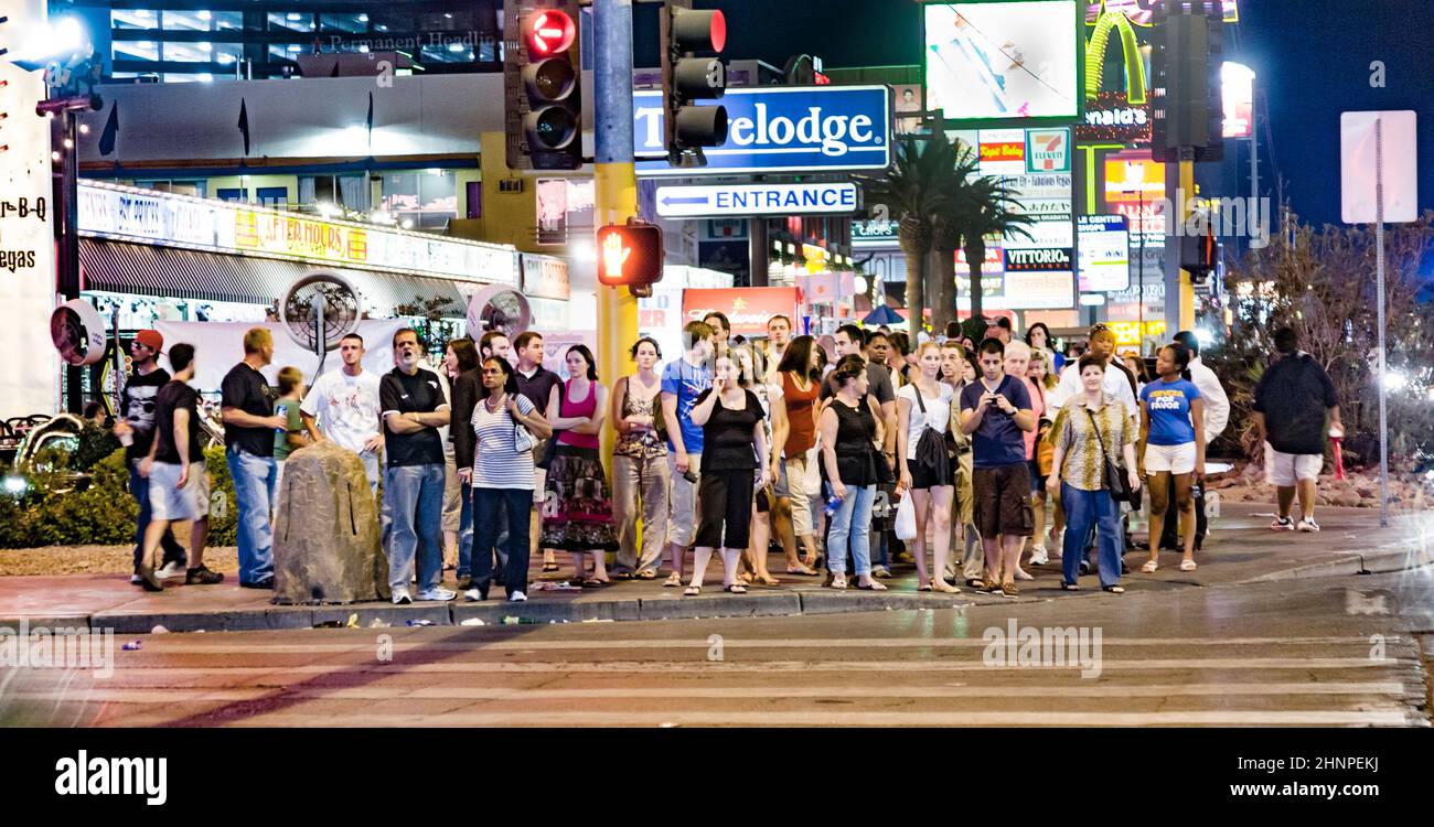pedestrians wait at the Strip in Las Vegas for green light to cross the