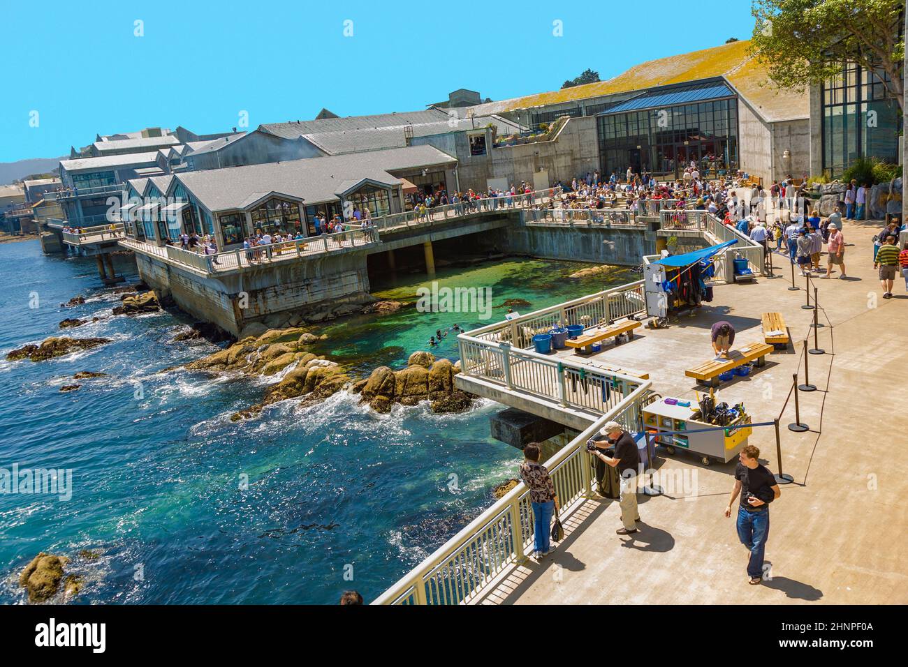 people enjoy the view to Monterrey aquarium and ocean at the sightseeing platform Stock Photo