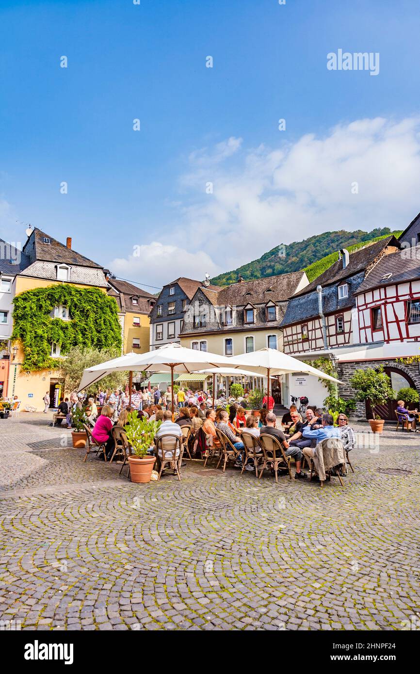 people enjoy the summer day at market place with medival half timbered houses in Bernkastel-Kues Stock Photo