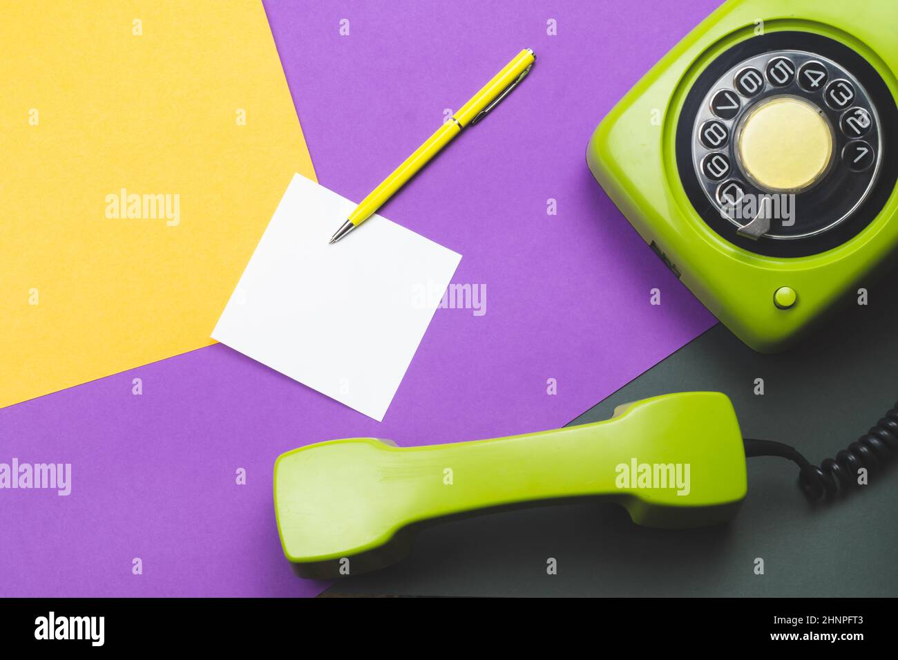 Classic phone with handset. pen with a note. office background. vintage