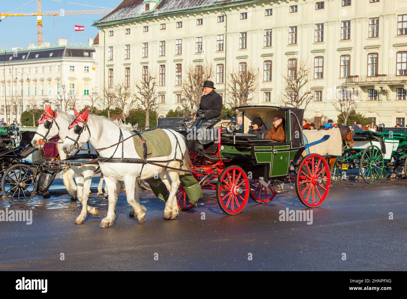 driver of the fiaker with tourists in vienna Stock Photo
