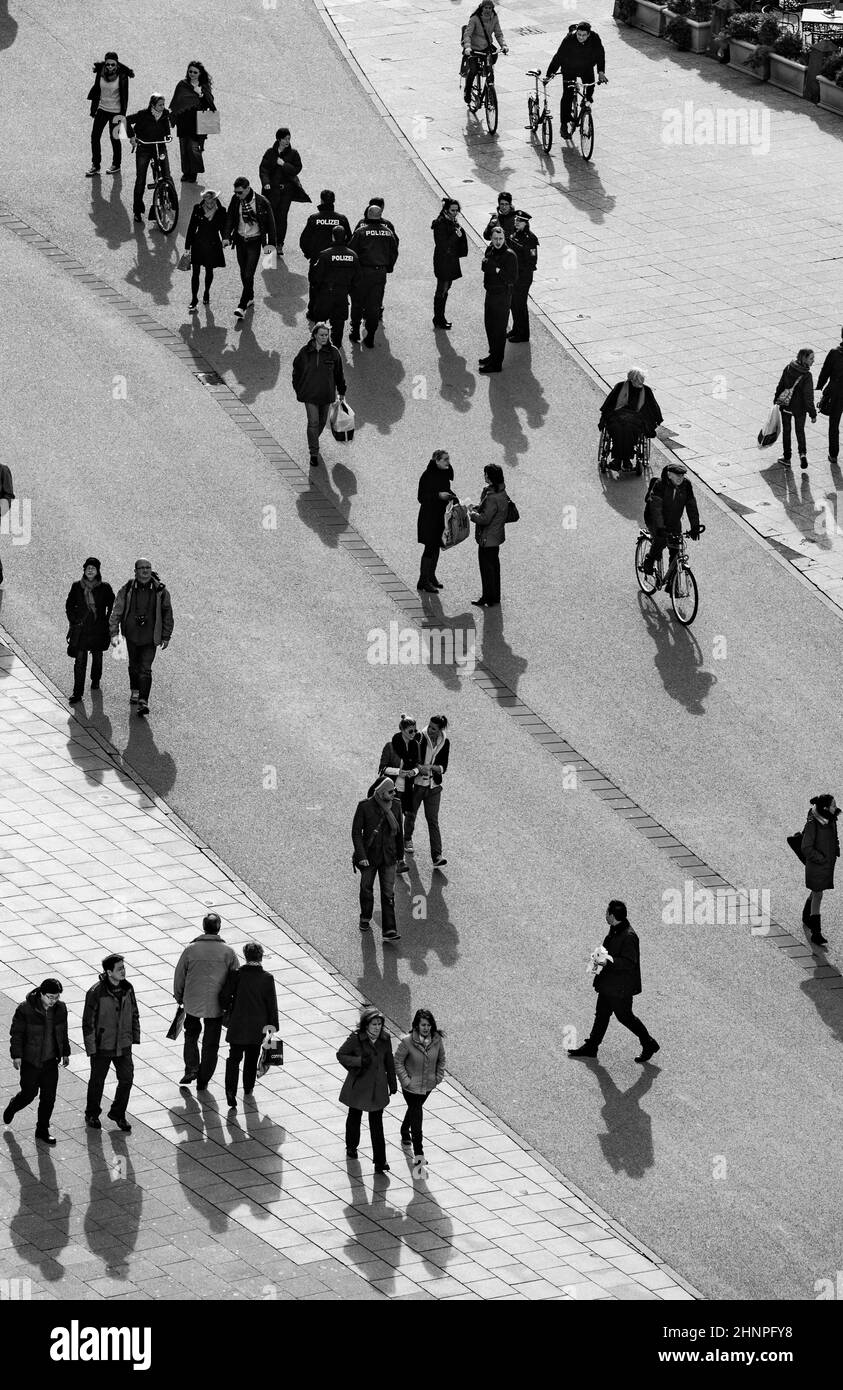 people walking at the street with long shadows Stock Photo