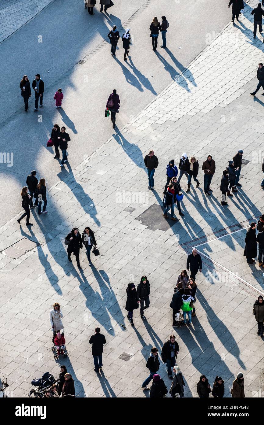 people walking at the street with long shadows Stock Photo - Alamy