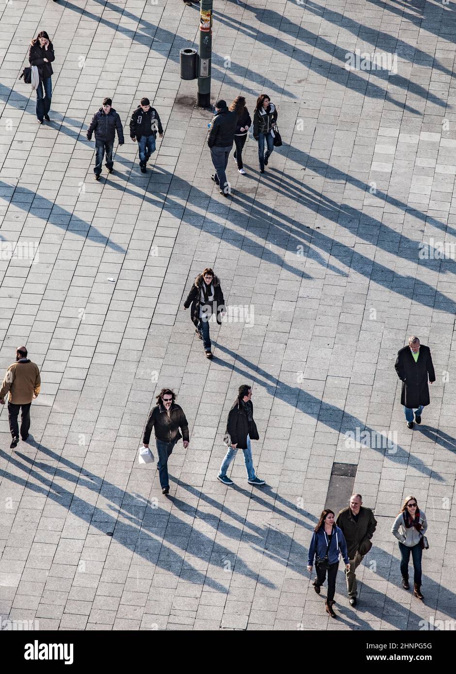 people walking at the street with long shadows Stock Photo - Alamy