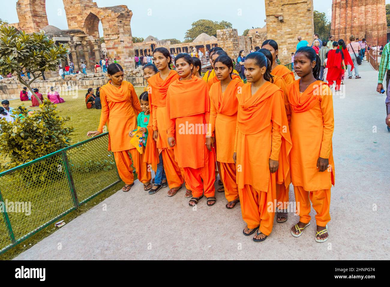 group of school girls pose in front of Qutb Minar Stock Photo