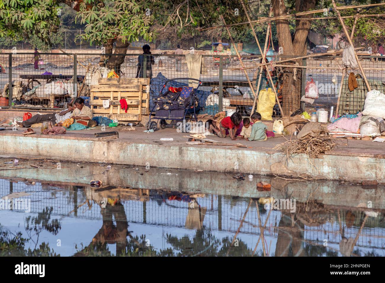 poor people live at the promenade of a canal near  Meena Bazaar Market in Old Delhi, India. Stock Photo