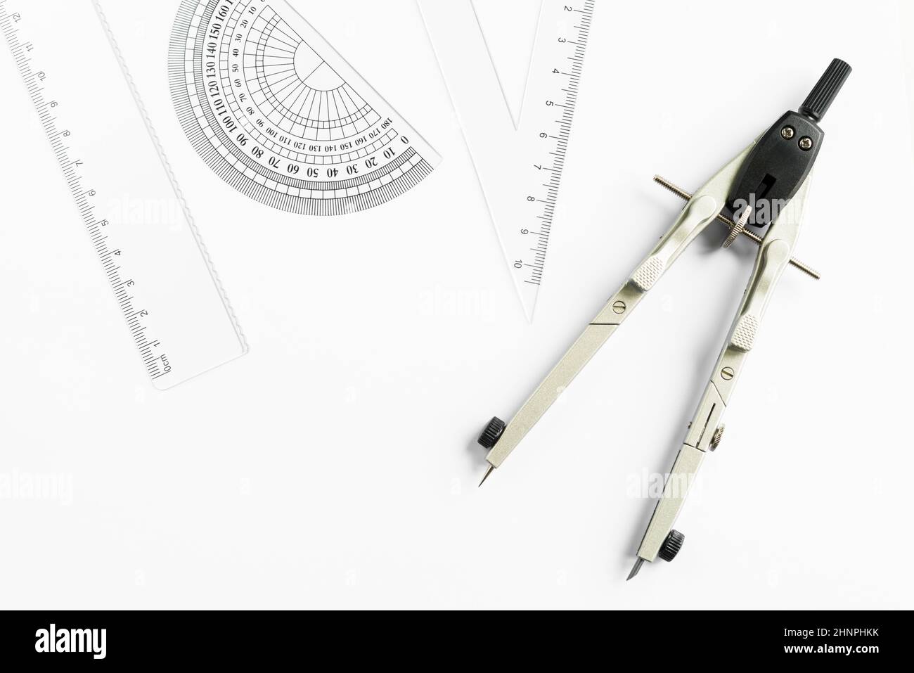 Compass and other measuring equipment on white paper Stock Photo - Alamy