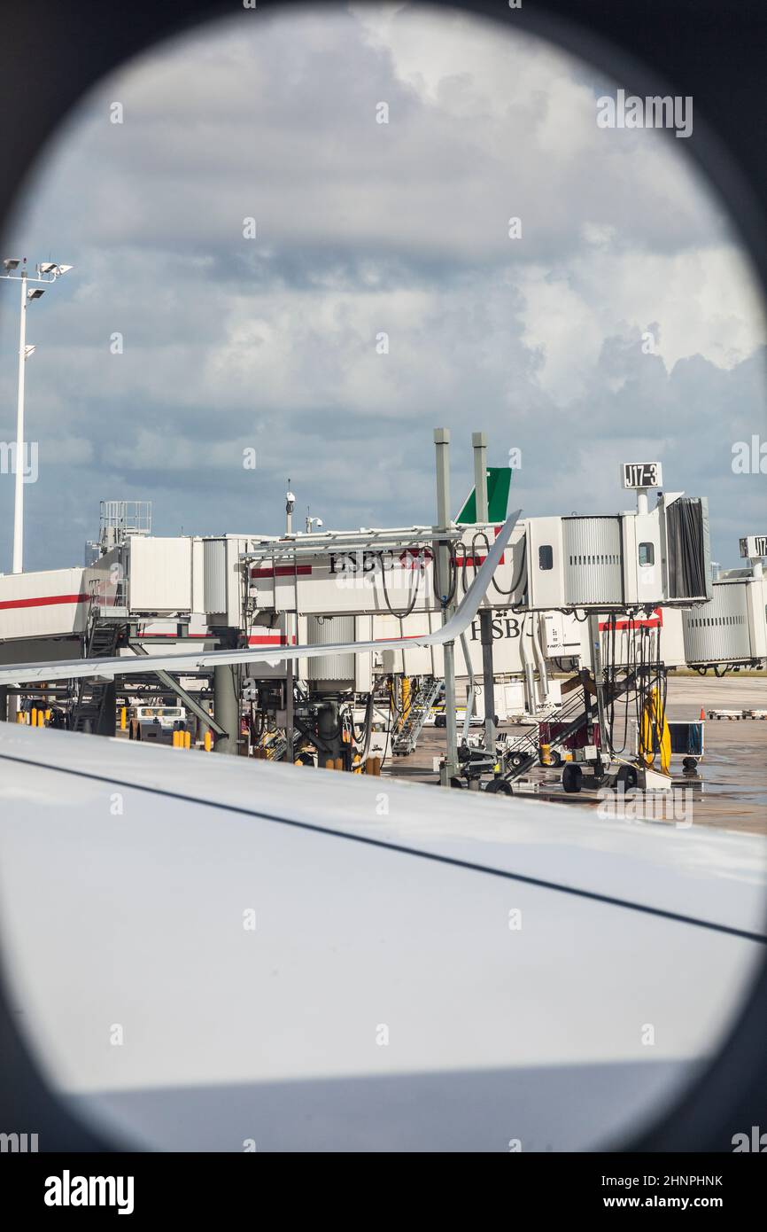 view through aircraft window to passenger bridge of Miami international airport Stock Photo