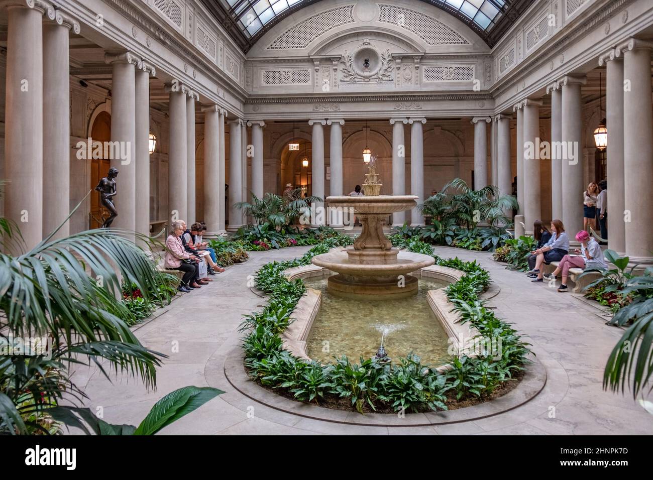 people rest in the atrium of the Frick Collection, former 5th Avenue mansion of steel magnate Henry Clay Frick Stock Photo