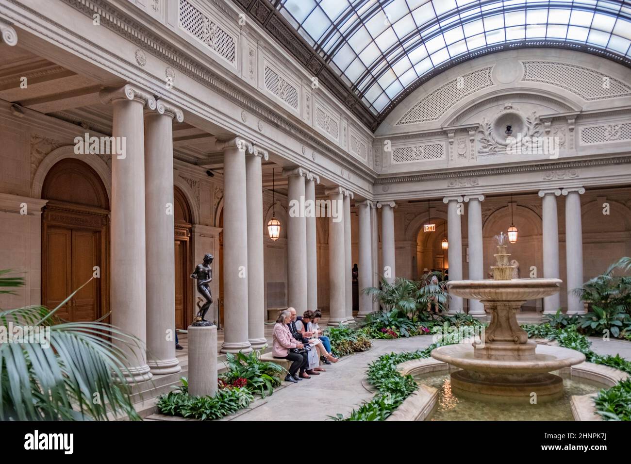 people rest in the atrium of the Frick Collection, former 5th Avenue mansion of steel magnate Henry Clay Frick Stock Photo