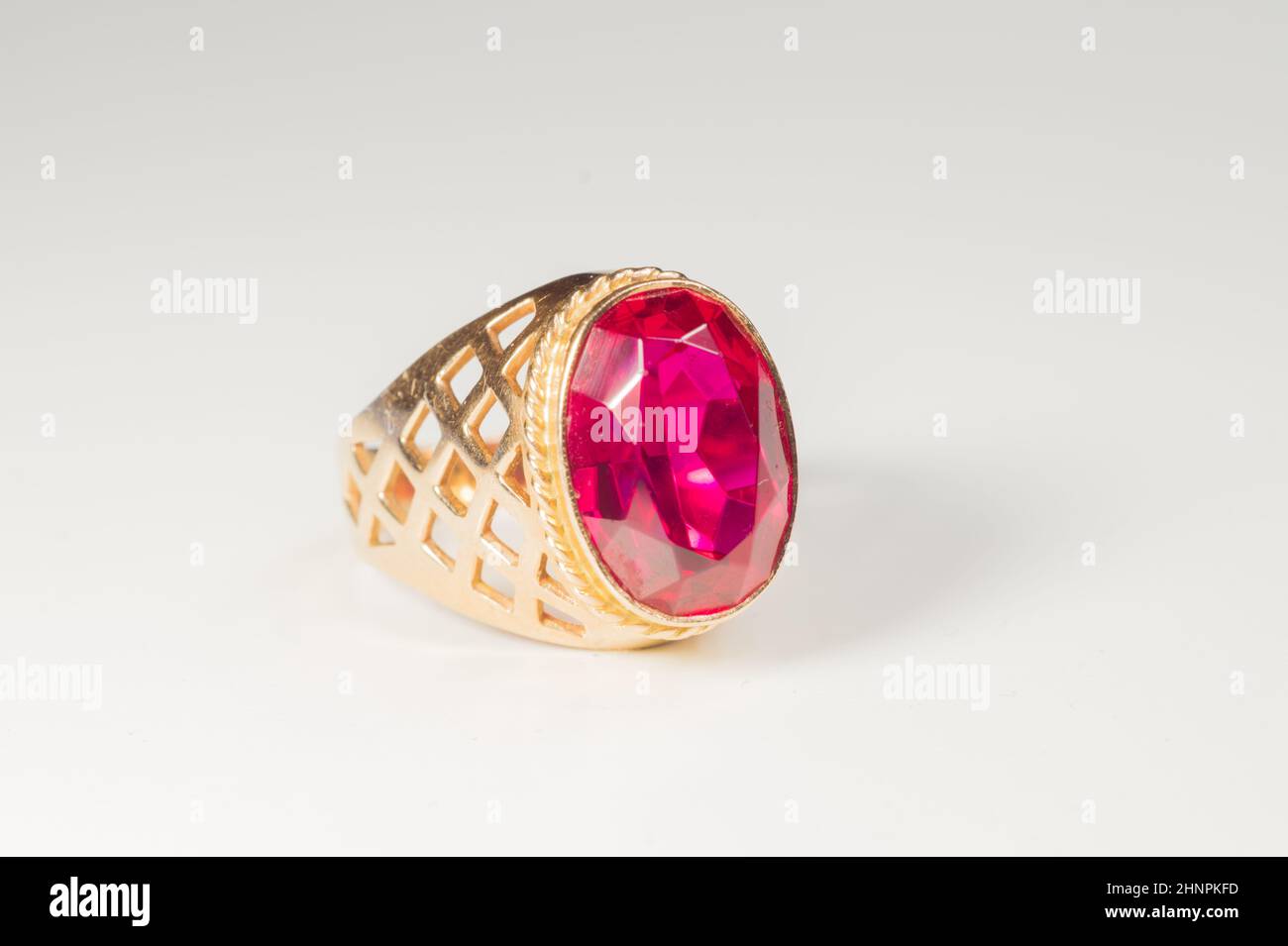 Golden ring with ruby isolated on white background Stock Photo