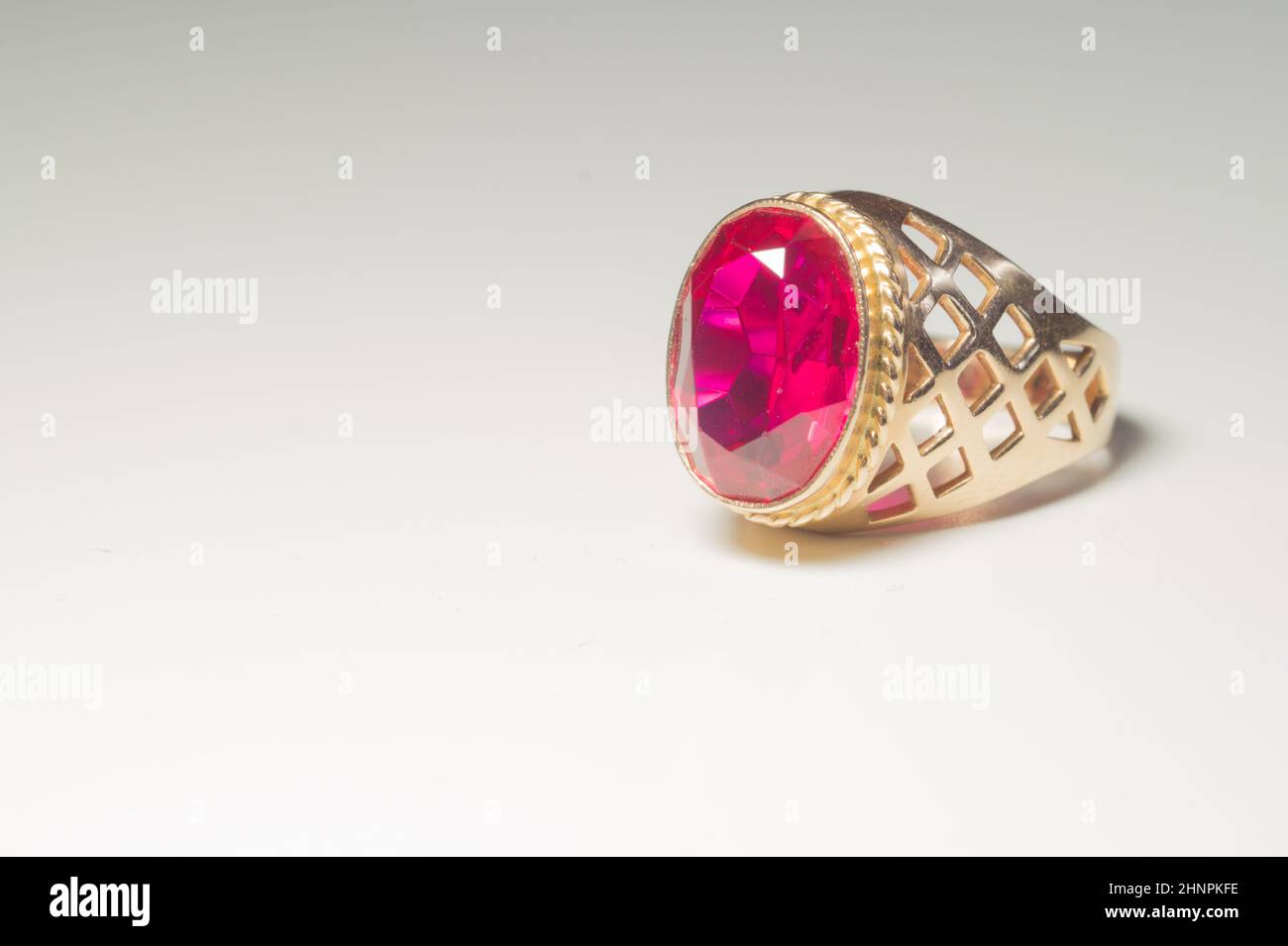 Golden ring with ruby isolated on white background Stock Photo