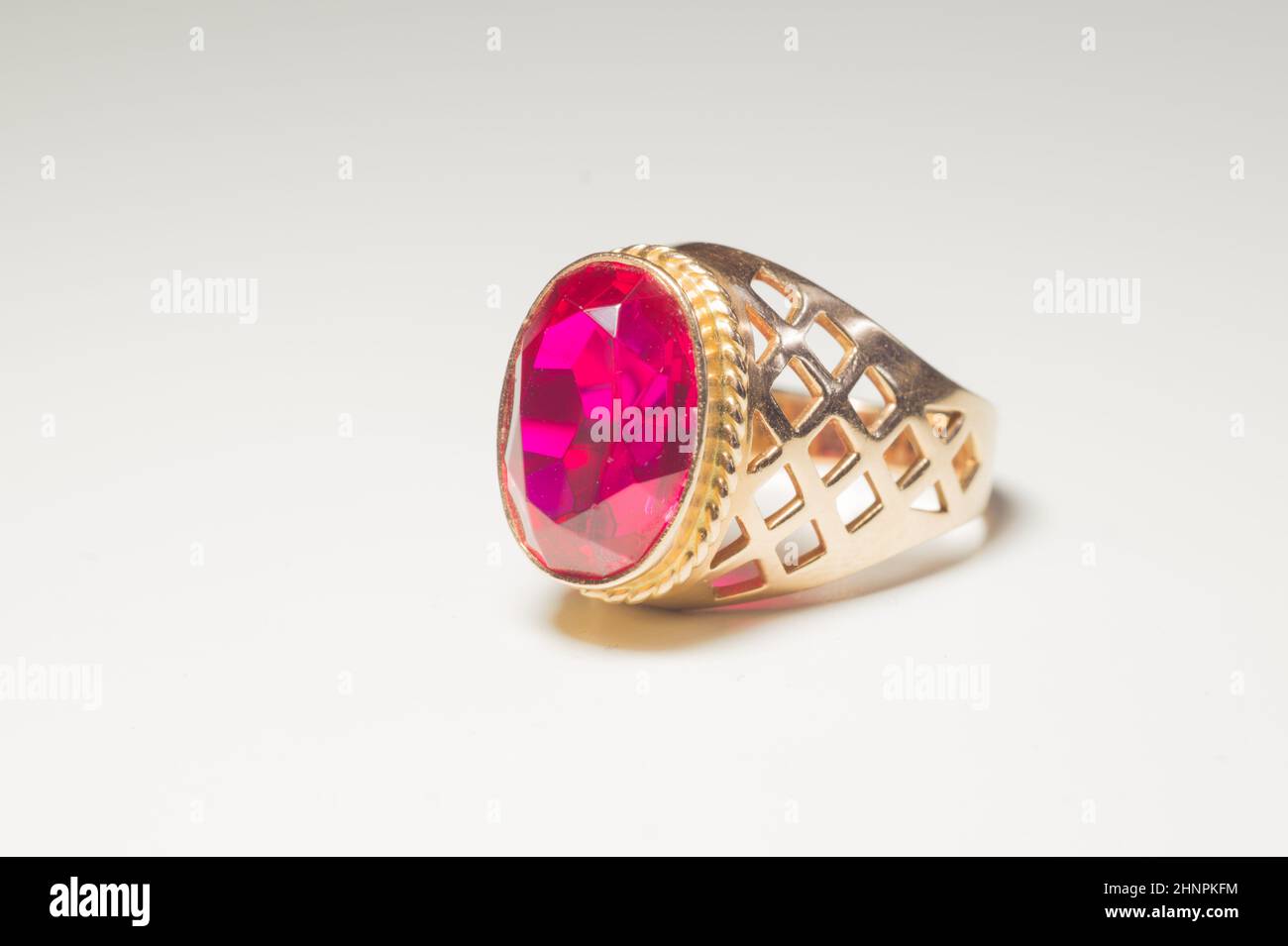 Golden ring with ruby isolated on white background Stock Photo