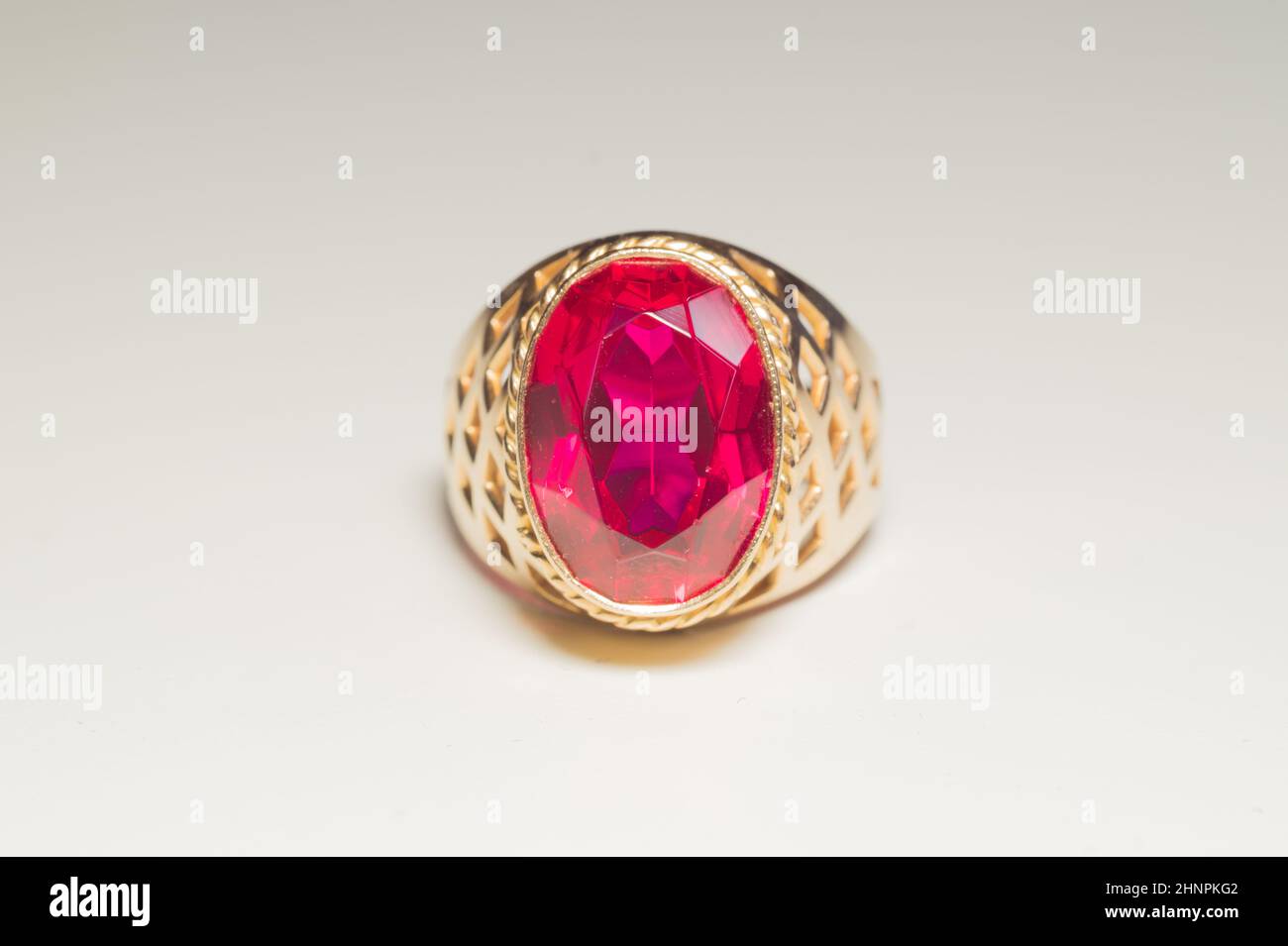 Golden ring with ruby isolated on white background Stock Photo