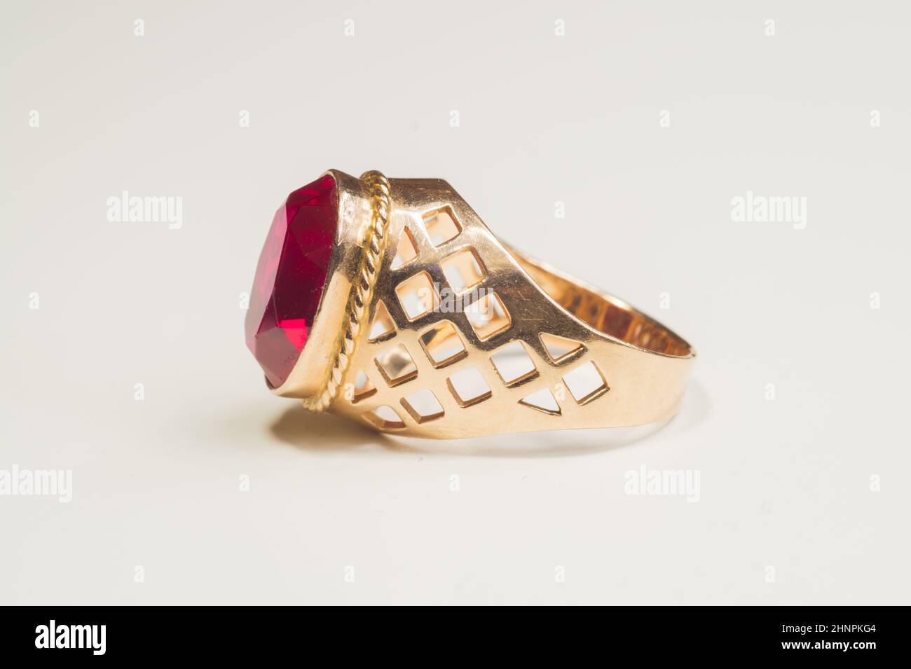 Golden ring with ruby isolated on white background Stock Photo