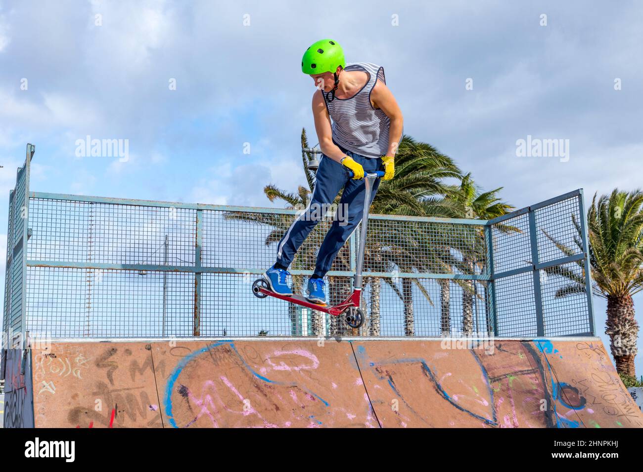 boy jumping at the skate park over a ramp Stock Photo Alamy