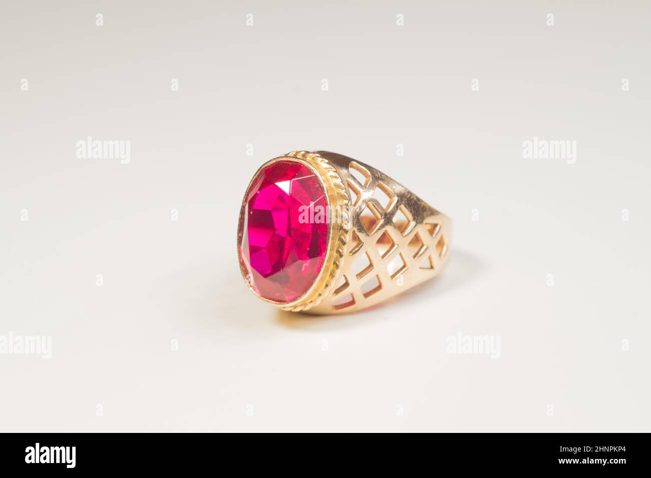 Golden ring with ruby isolated on white background Stock Photo