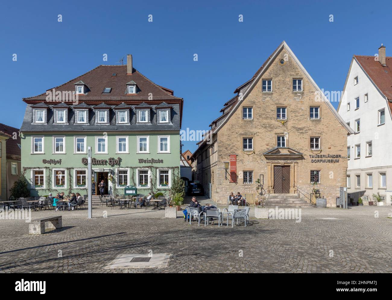 tourists relax at the town central square of Weikersheim along the romantic road Stock Photo