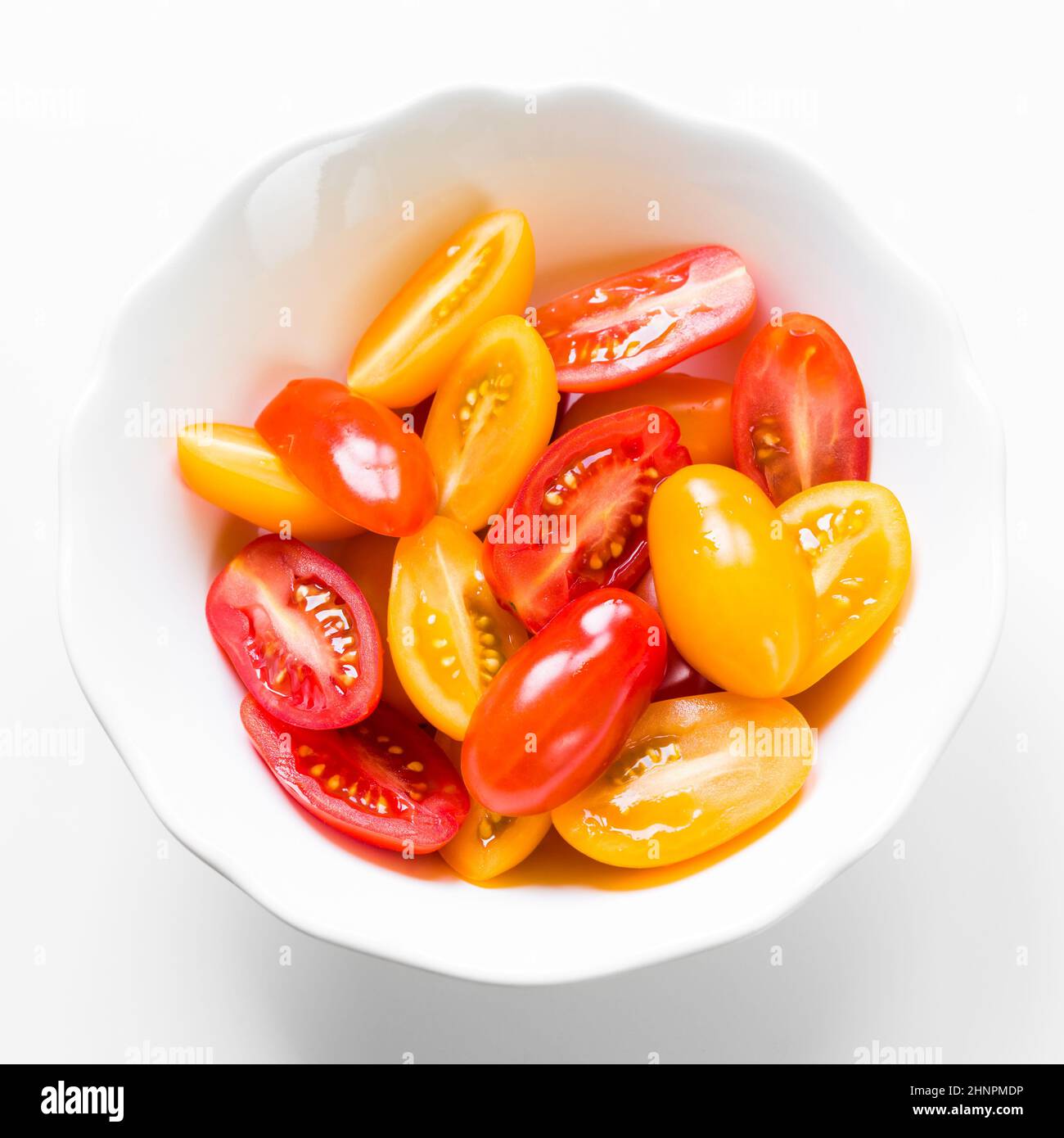 Red and yellow cherry tomatoes in white bowl on white background Stock ...