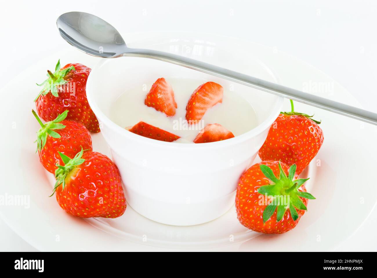 Fresh strawberries with creamy yoghurt and spoon Stock Photo - Alamy