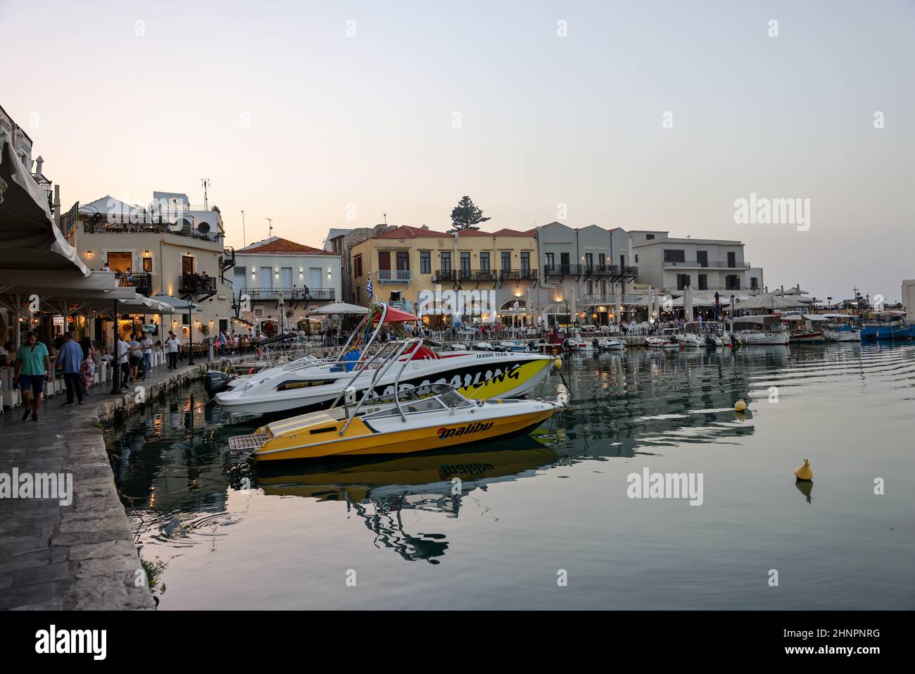 Waterside restaurants in early evening light at Old Venetian Harbor in Rethymnon. Crete Stock Photo