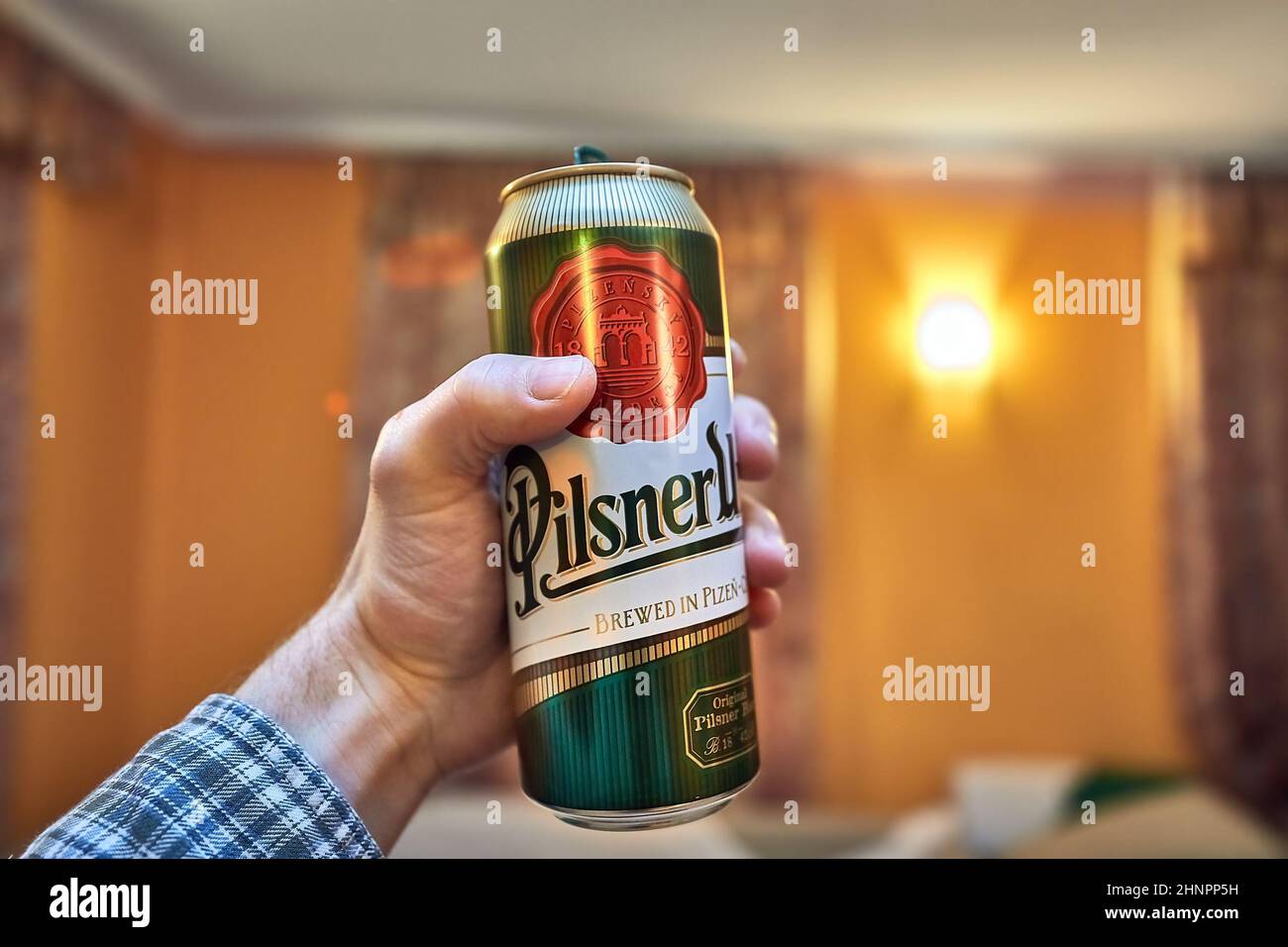 Holding beer in a house Stock Photo